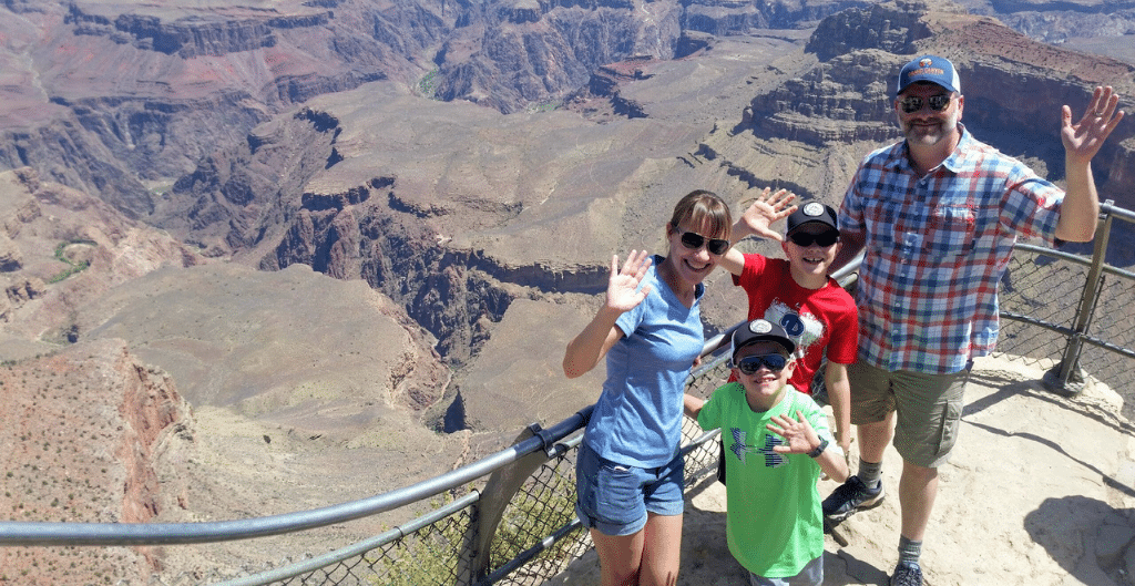 family of four waving to the camera while visiting arizona