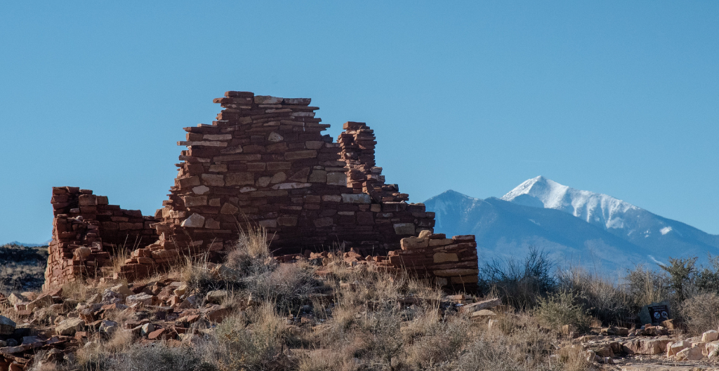 wupatki national monument in northern arizona with a springtime snow capped mountain in the background