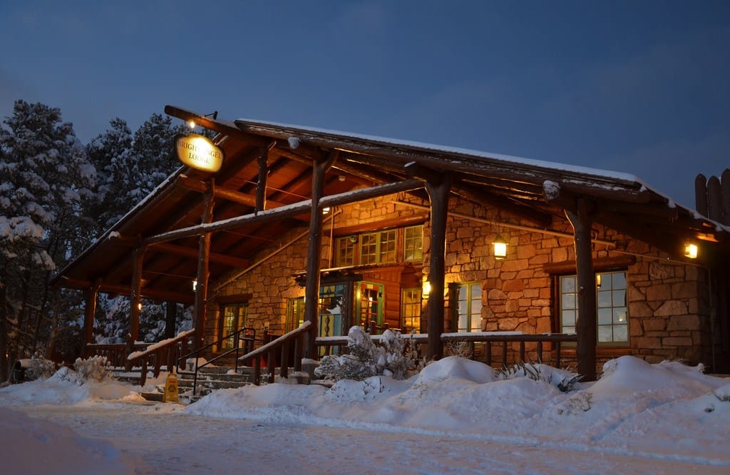 a glowing lodge with snow around it