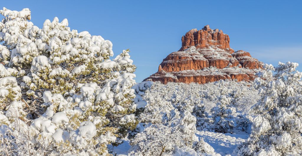 snow covers the red rock landscape in sedona