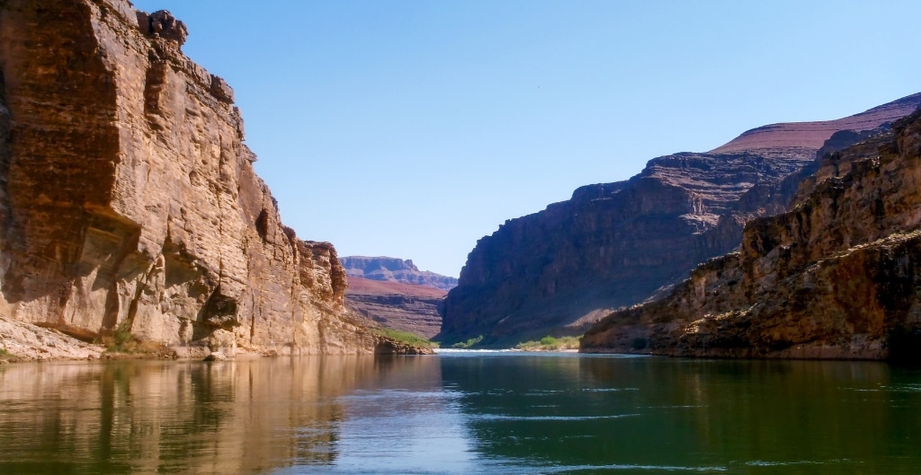 raft floating down the colorado river in the grand canyon