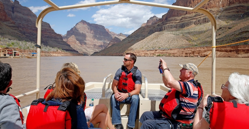 people sitting on a motorized boat on the colorado river