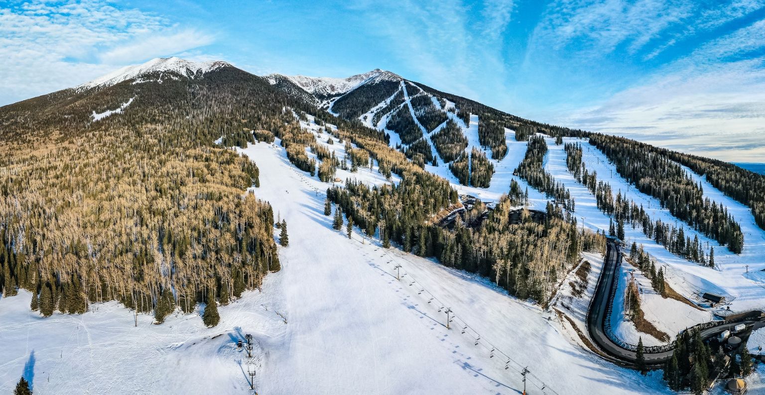 ski runs at arizona snowbowl in front of a blue sky