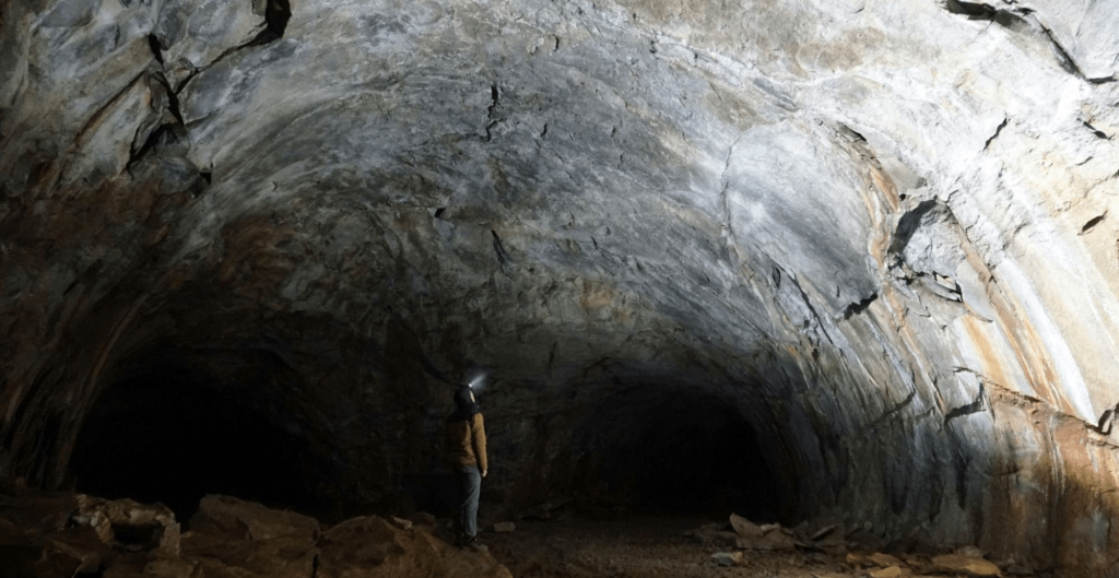 person standing in the lava river cave near flagstaff arizona